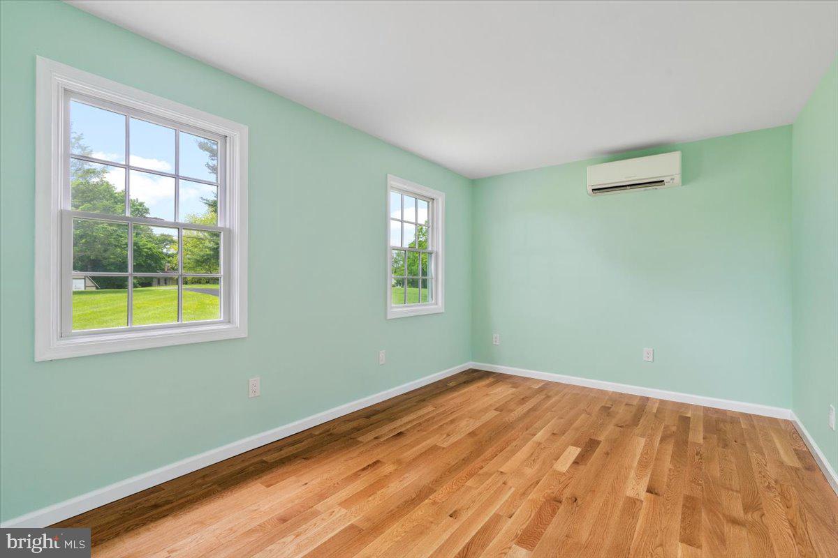6117 Long Branch Road Frederick, MD 21701 - Photo 25 of 75 a view of a room with wooden floor and windows