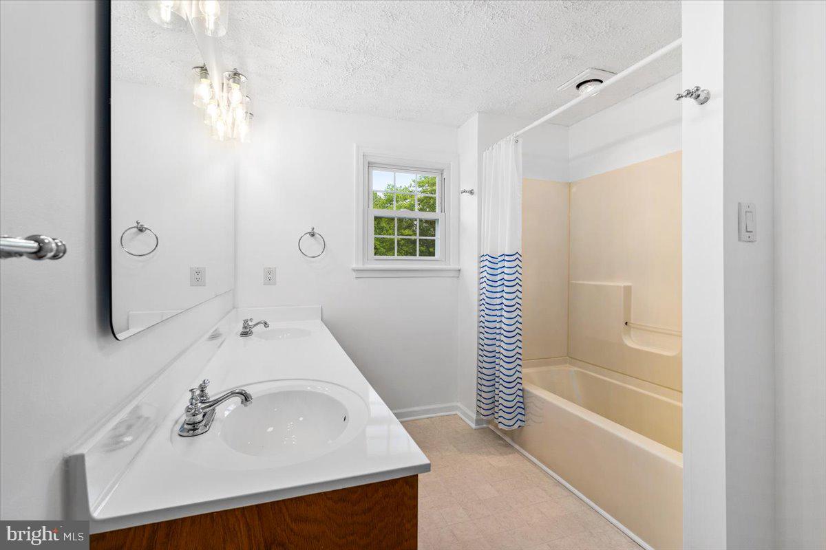 6117 Long Branch Road Frederick, MD 21701 - Photo 30 of 75 a bathroom with a sink a shower and a mirror