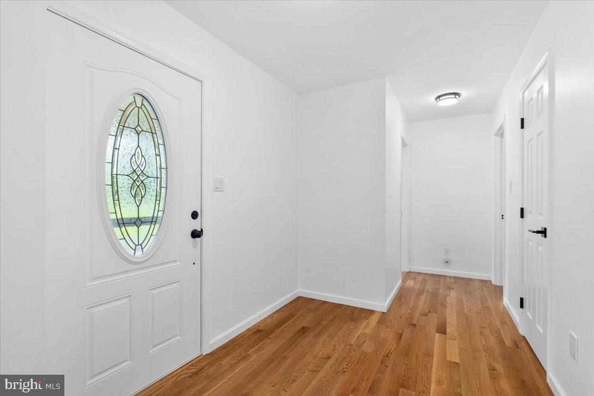 6117 Long Branch Road Frederick, MD 21701 - Photo 4 of 75 a view of empty room with wooden floor and fan