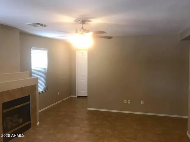 a view of a livingroom with a fireplace and window