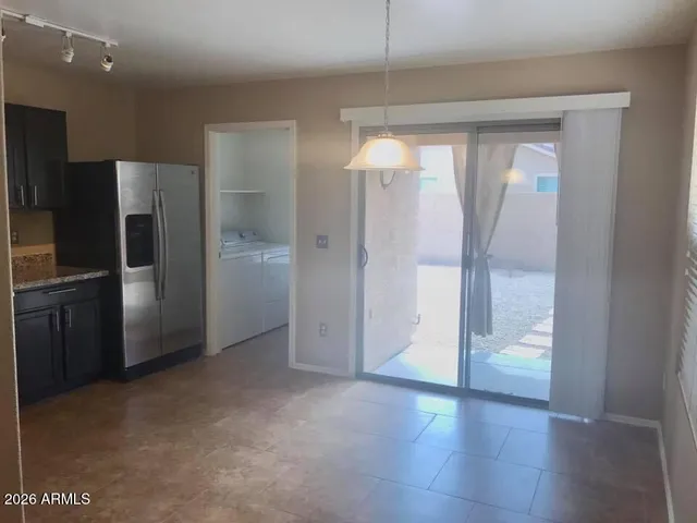 a kitchen with stainless steel appliances granite countertop a stove a sink dishwasher a refrigerator and a microwave