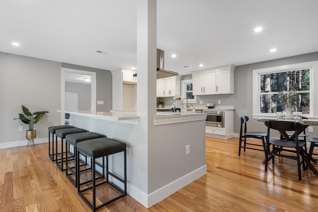 286 Hudson Road Sudbury, MA 01776 - Photo 6 of 34 a kitchen with stainless steel appliances kitchen island granite countertop a dining table chairs and view living room