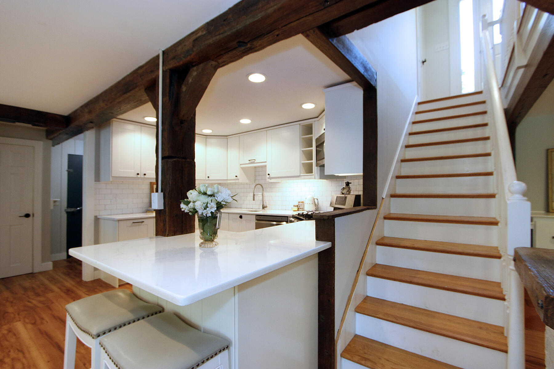 70 Deerfield Lane Eastham, MA 02642 - Photo 13 of 48 a kitchen with stainless steel appliances a dining table chairs and wooden floor