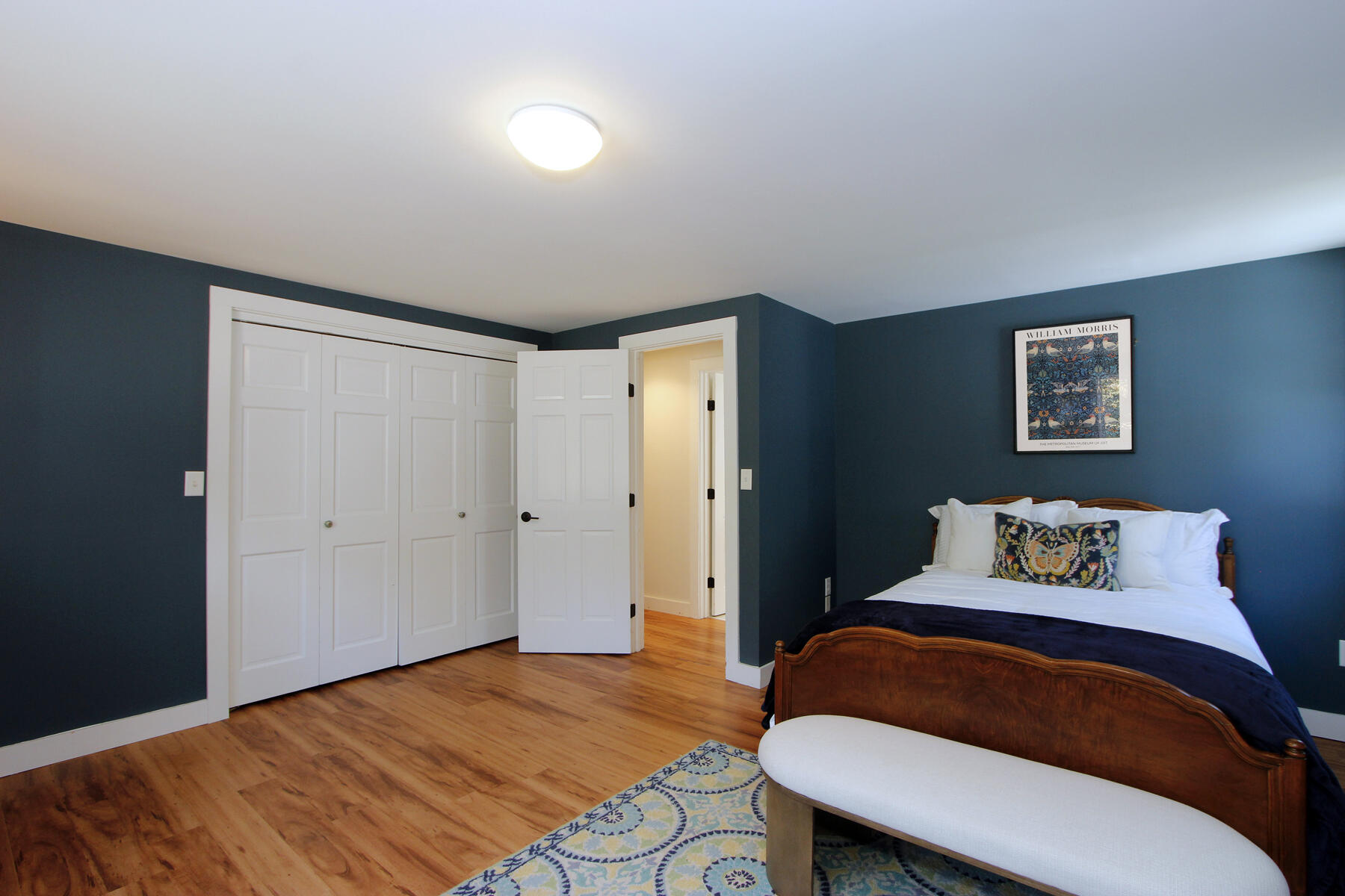 70 Deerfield Lane Eastham, MA 02642 - Photo 16 of 48 a bedroom with a bed and a painting on the wall
