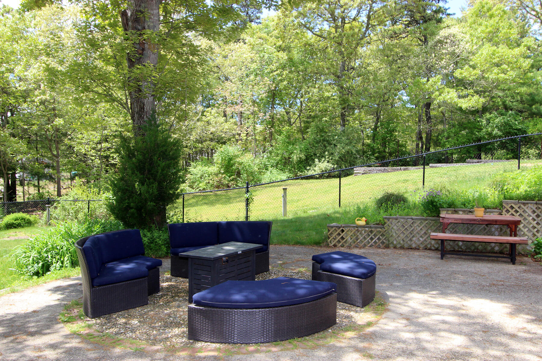 70 Deerfield Lane Eastham, MA 02642 - Photo 32 of 48 a view of a backyard with furniture and a fire pit
