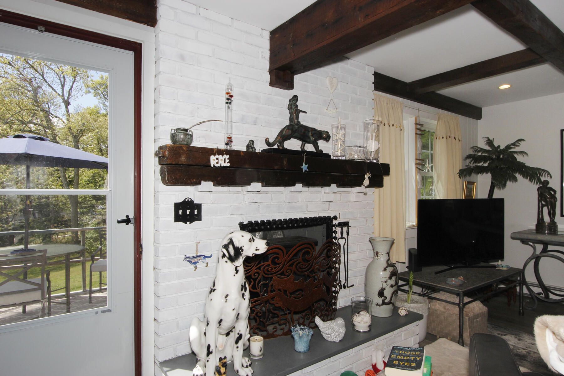 70 Deerfield Lane Eastham, MA 02642 - Photo 40 of 48 a living room with furniture a fireplace and a flat screen tv