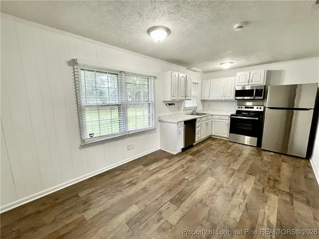 a kitchen with refrigerator and window