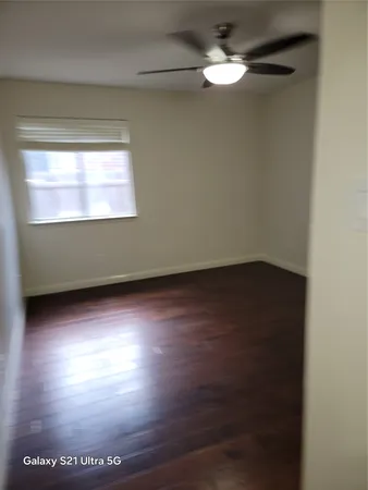 a view of room with hardwood floor and a window