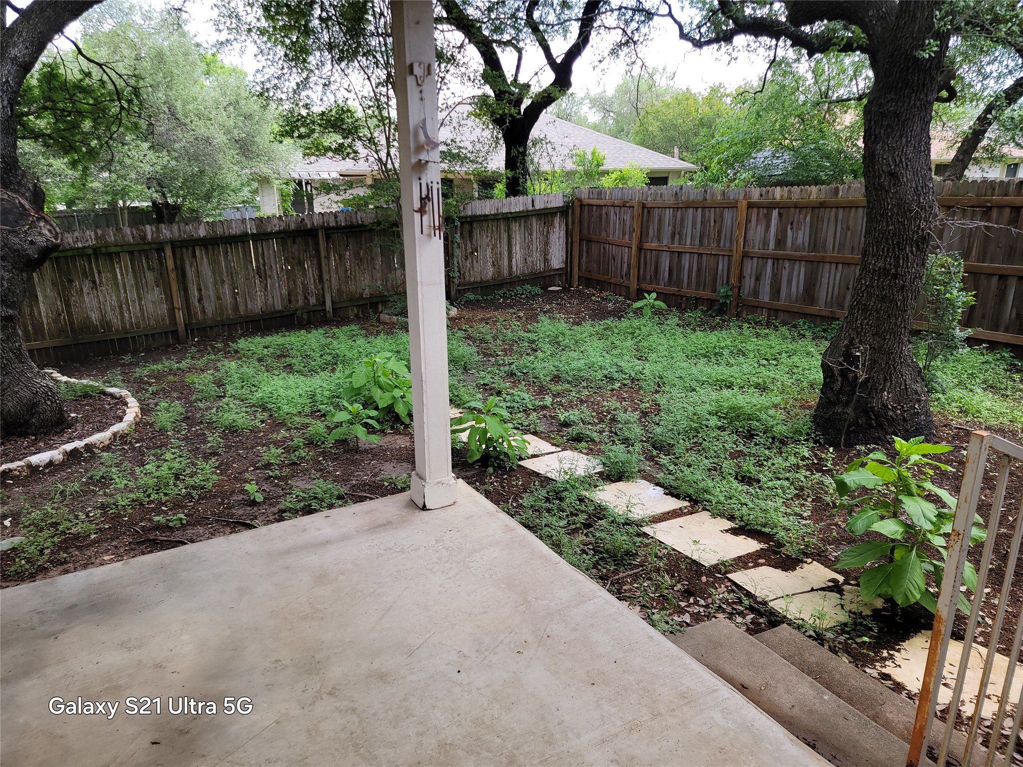 3356 Cantera Way Round Rock, TX 78681 - Photo 20 of 22 a view of a backyard with large trees and wooden fence