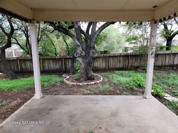 a view of backyard with plants and outdoor seating