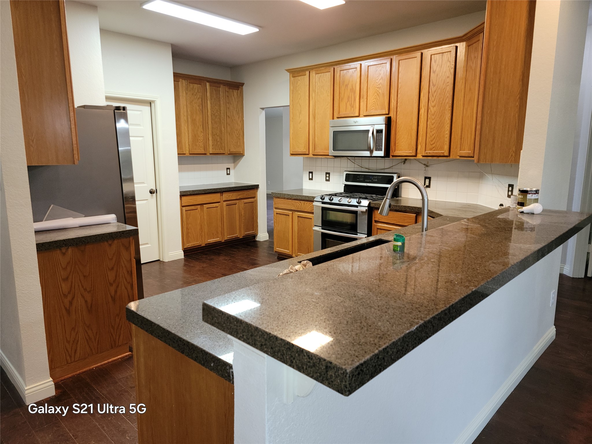 3356 Cantera Way Round Rock, TX 78681 - Photo 3 of 22 a kitchen with stainless steel appliances granite countertop a sink a stove and a refrigerator