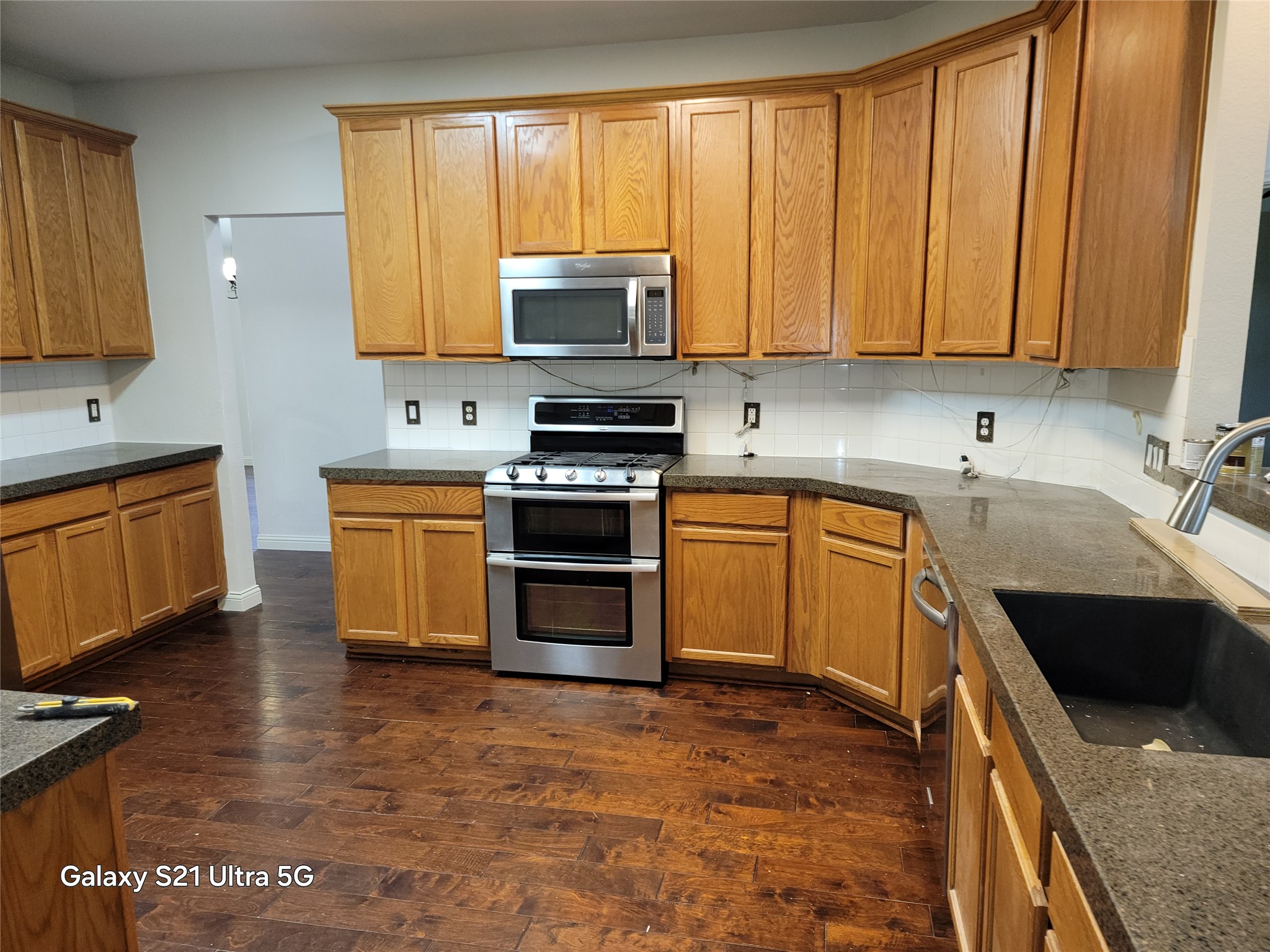 3356 Cantera Way Round Rock, TX 78681 - Photo 5 of 22 a kitchen with stainless steel appliances granite countertop a stove sink and cabinets