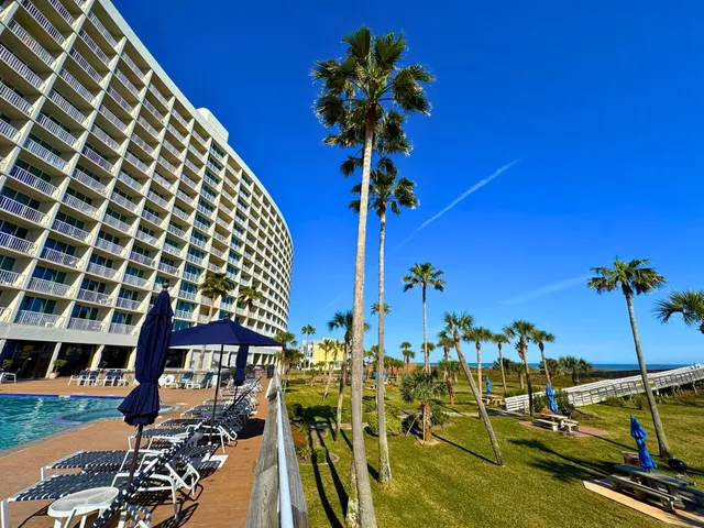 a view of a swimming pool with a table and chairs