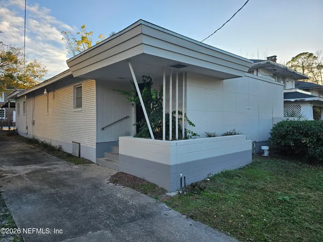 a view of wooden house with a yard