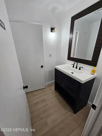 a bathroom with a sink vanity and mirror