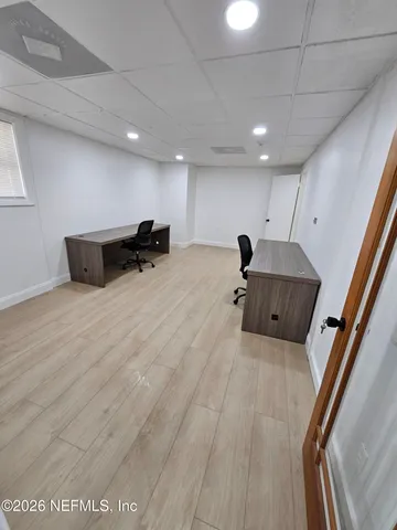 a living room with furniture and air hockey table