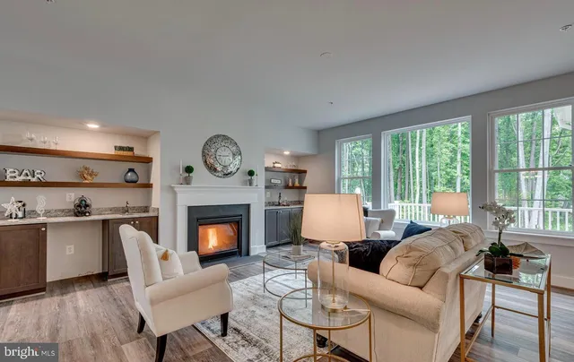 a living room with furniture fireplace and a large window