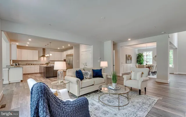 a living room with furniture and kitchen view