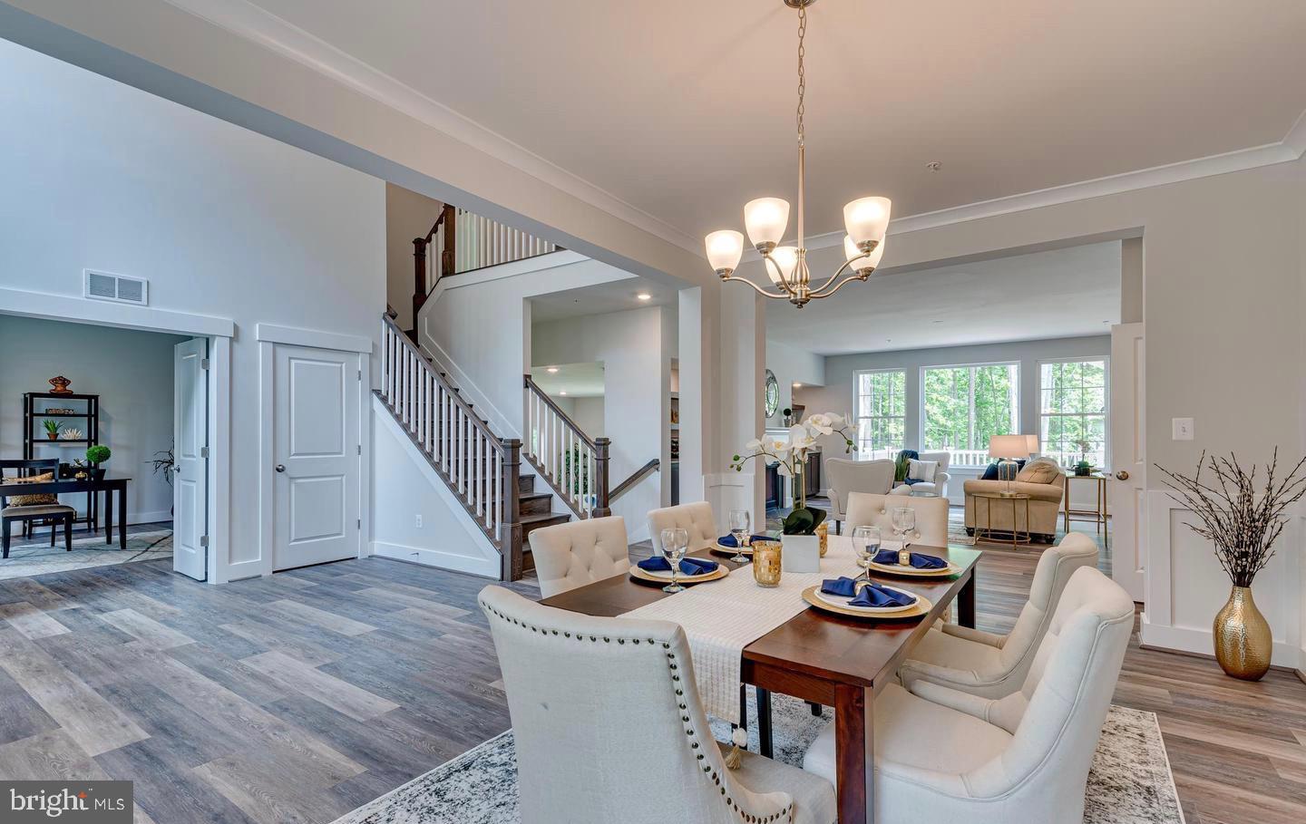 1319 German Driveway Hanover, MD 21076 - Photo 6 of 11 a living room with furniture a chandelier and a dining room