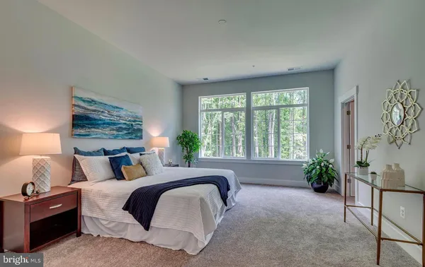 a bedroom with a bed and a potted plant