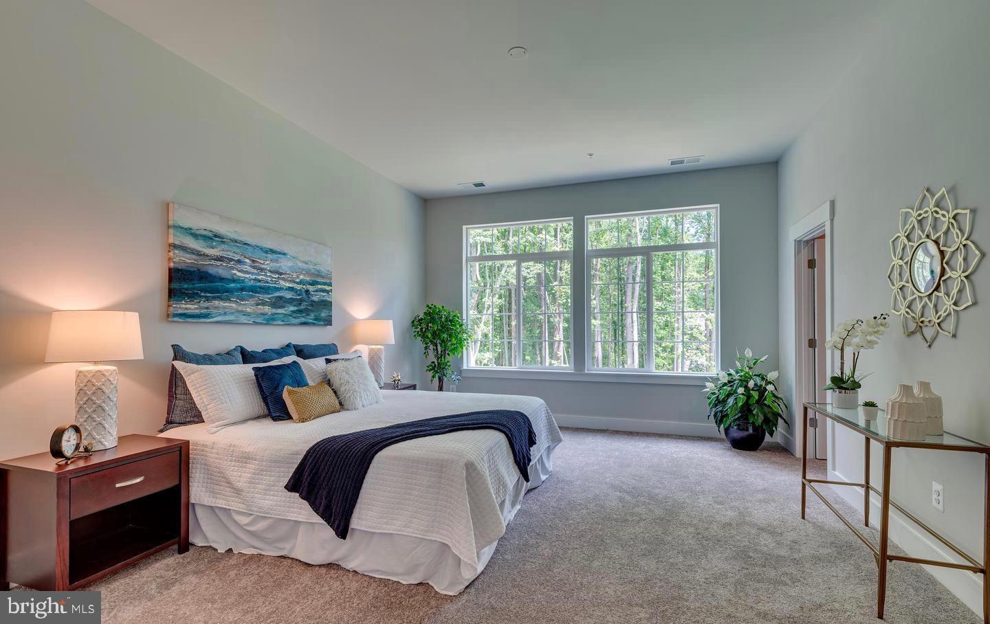 1319 German Driveway Hanover, MD 21076 - Photo 8 of 11 a bedroom with a bed and a potted plant