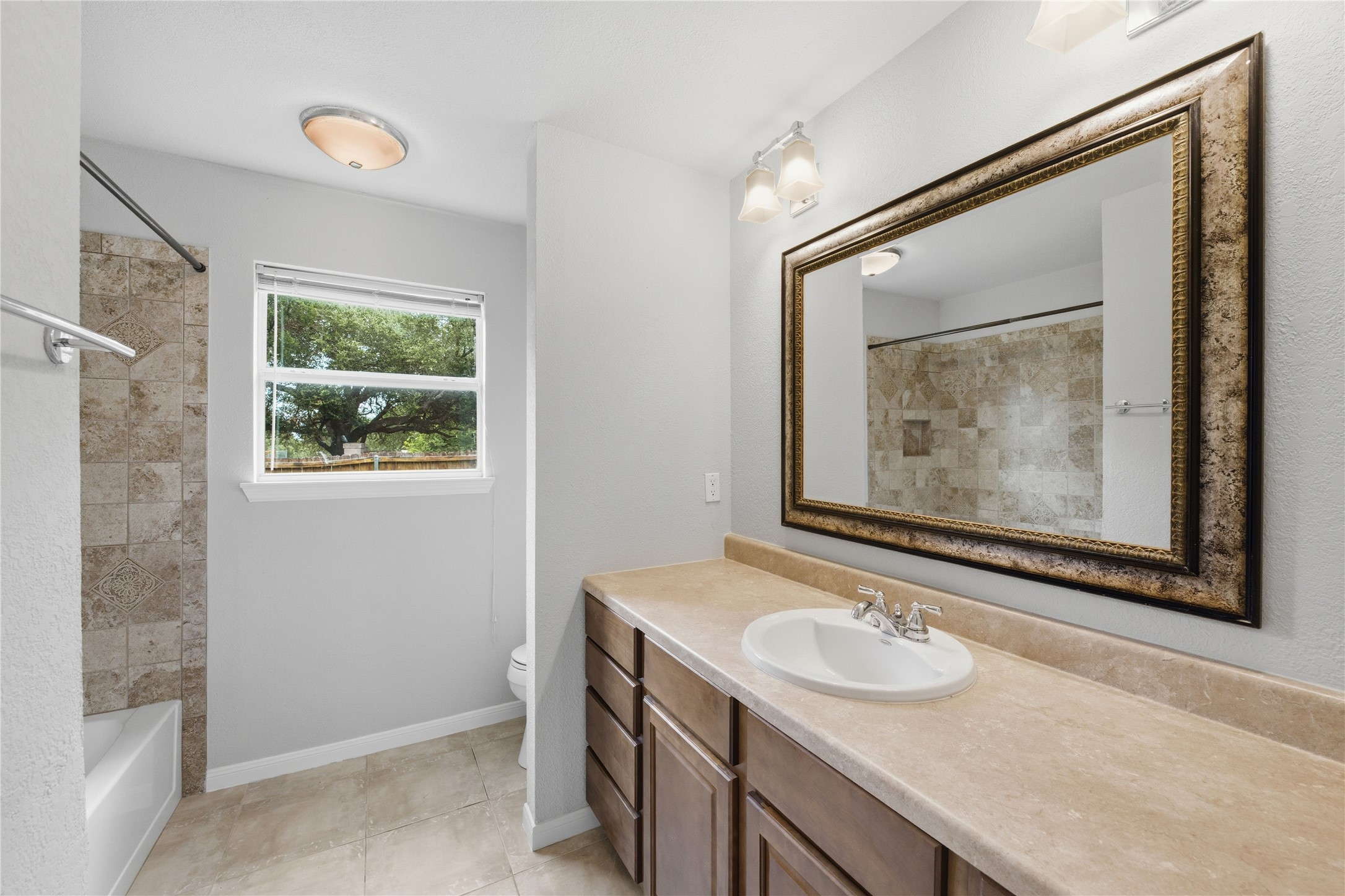 1317 Mimosa Pass Cedar Park, TX 78613 - Photo 14 of 20 a bathroom with a granite countertop sink a large mirror and a shower