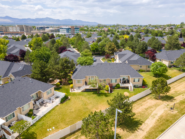 11881 Cottage View Lane Draper, UT 84020 - Photo 28 of 29 Rear exterior featuring a spacious patio, white picket fencing, and mature landscaping