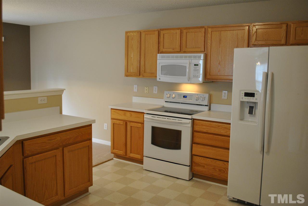 4709 Mocha Lane Raleigh, NC 27616 - Photo 3 of 25 a kitchen with a stove top oven and refrigerator