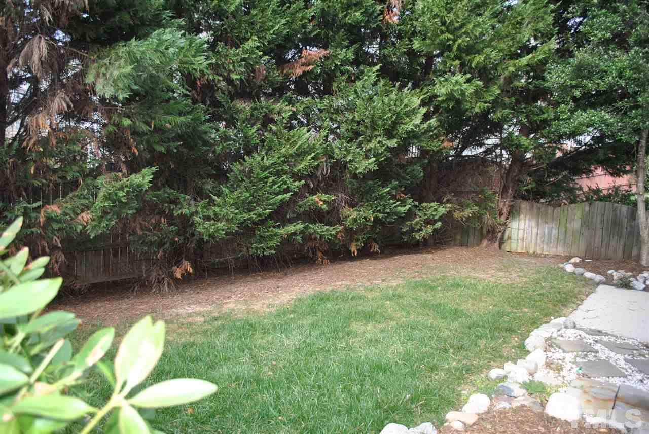 4709 Mocha Lane Raleigh, NC 27616 - Photo 22 of 25 a backyard of a house with lots of green space and a fountain