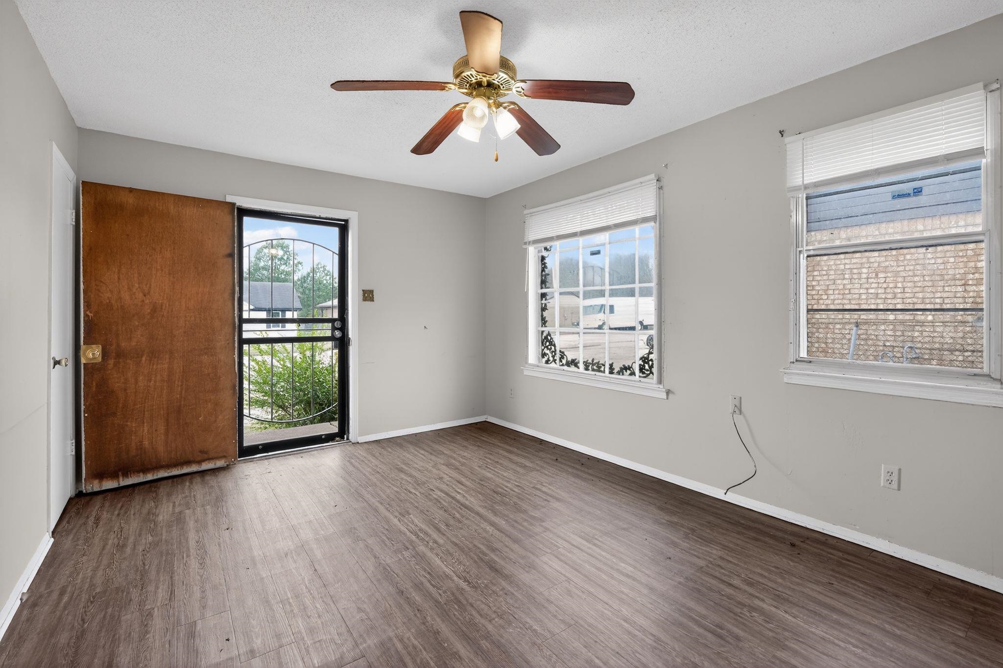 3420 Forrester Road Memphis, TN 38109 - Photo 6 of 30 Unfurnished room with dark wood-style flooring, a textured ceiling, and a ceiling fan