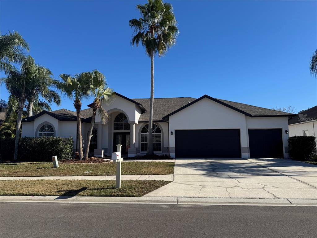 28724 Hanging Moss Loop Wesley Chapel, FL 33543 - Photo 1 of 30 a front view of a house with a yard