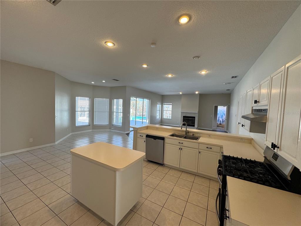 28724 Hanging Moss Loop Wesley Chapel, FL 33543 - Photo 12 of 30 a large white kitchen with a large window