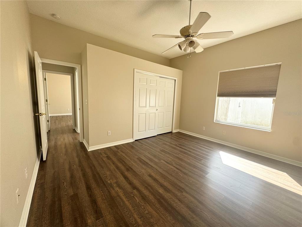 28724 Hanging Moss Loop Wesley Chapel, FL 33543 - Photo 18 of 30 wooden floor in an empty room with a window