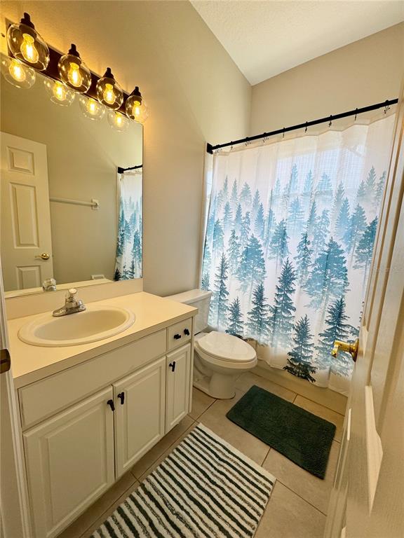 28724 Hanging Moss Loop Wesley Chapel, FL 33543 - Photo 22 of 30 a bathroom with a double vanity sink toilet and shower