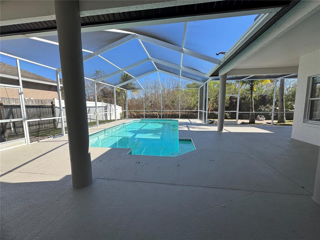28724 Hanging Moss Loop Wesley Chapel, FL 33543 - Photo 24 of 30 a view of a backyard of a house with a porch