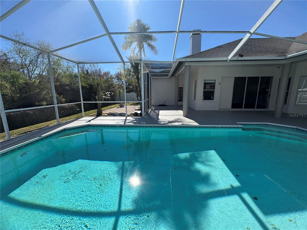 28724 Hanging Moss Loop Wesley Chapel, FL 33543 - Photo 27 of 30 a backyard of a house with yard table and chairs