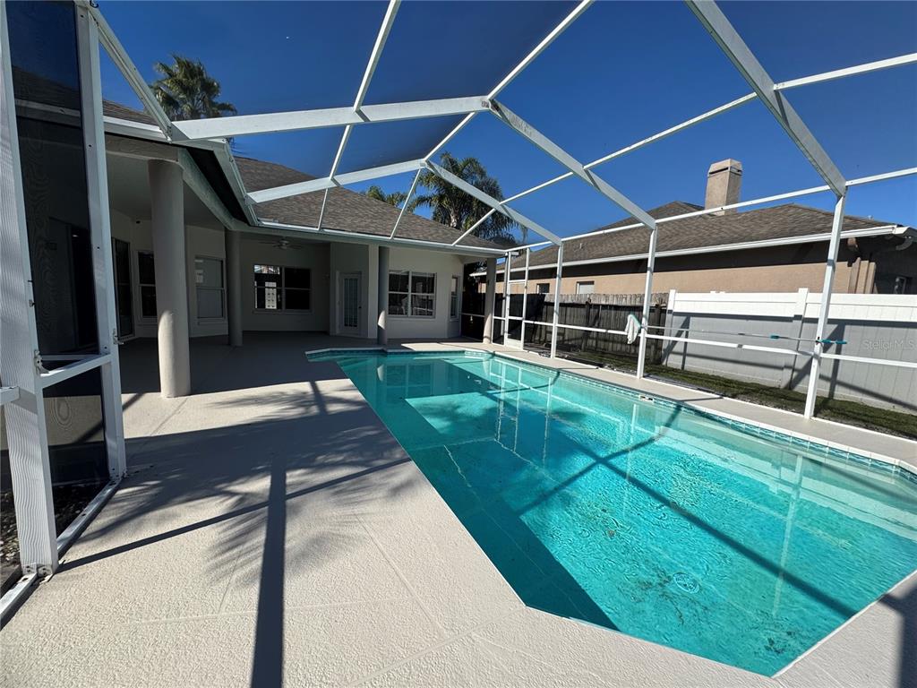 28724 Hanging Moss Loop Wesley Chapel, FL 33543 - Photo 28 of 30 a view of a backyard with table and chairs