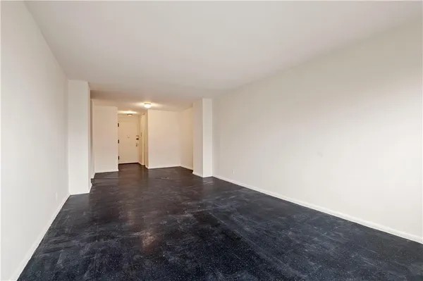 a view of an empty room and wooden floor