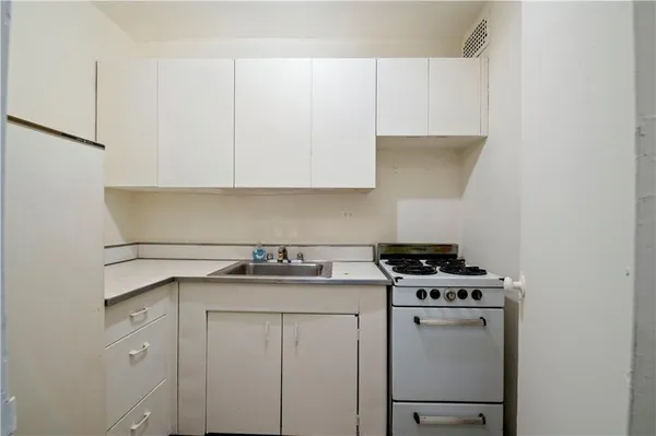 a kitchen with cabinets and appliances