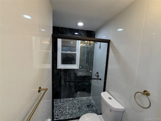 a bathroom with a granite countertop sink toilet and a mirror