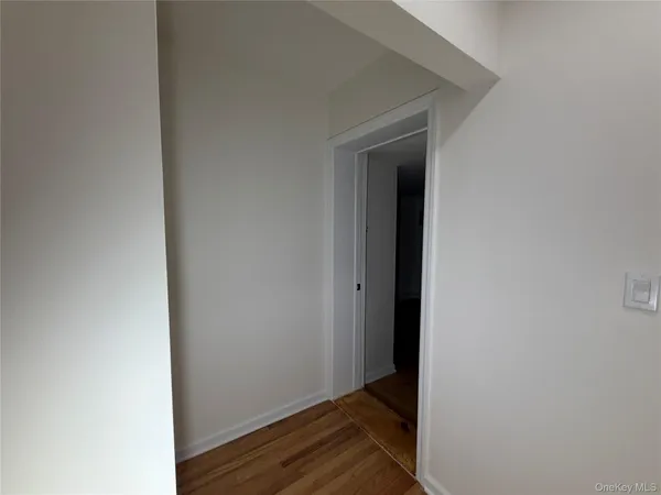 a view of room with wooden floor