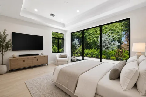 a bedroom with a large bed and a large window