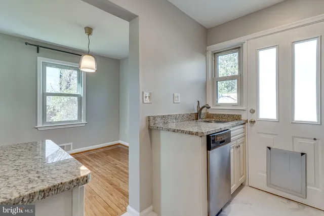 a kitchen with granite countertop sink and window