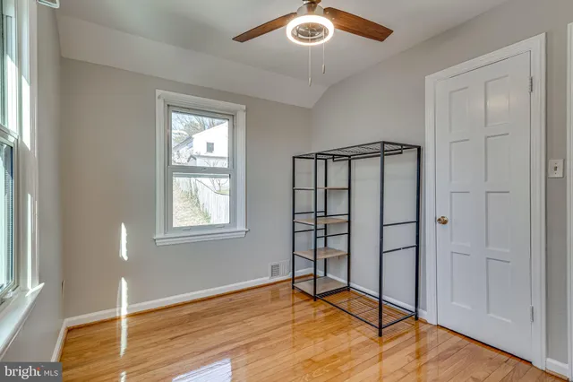 a view of empty room with wooden floor