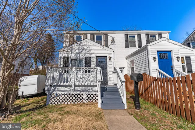 a front view of a house with a fence