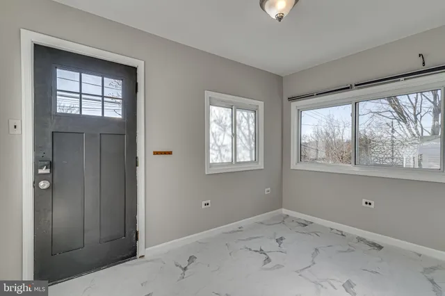 an empty room with windows and closet