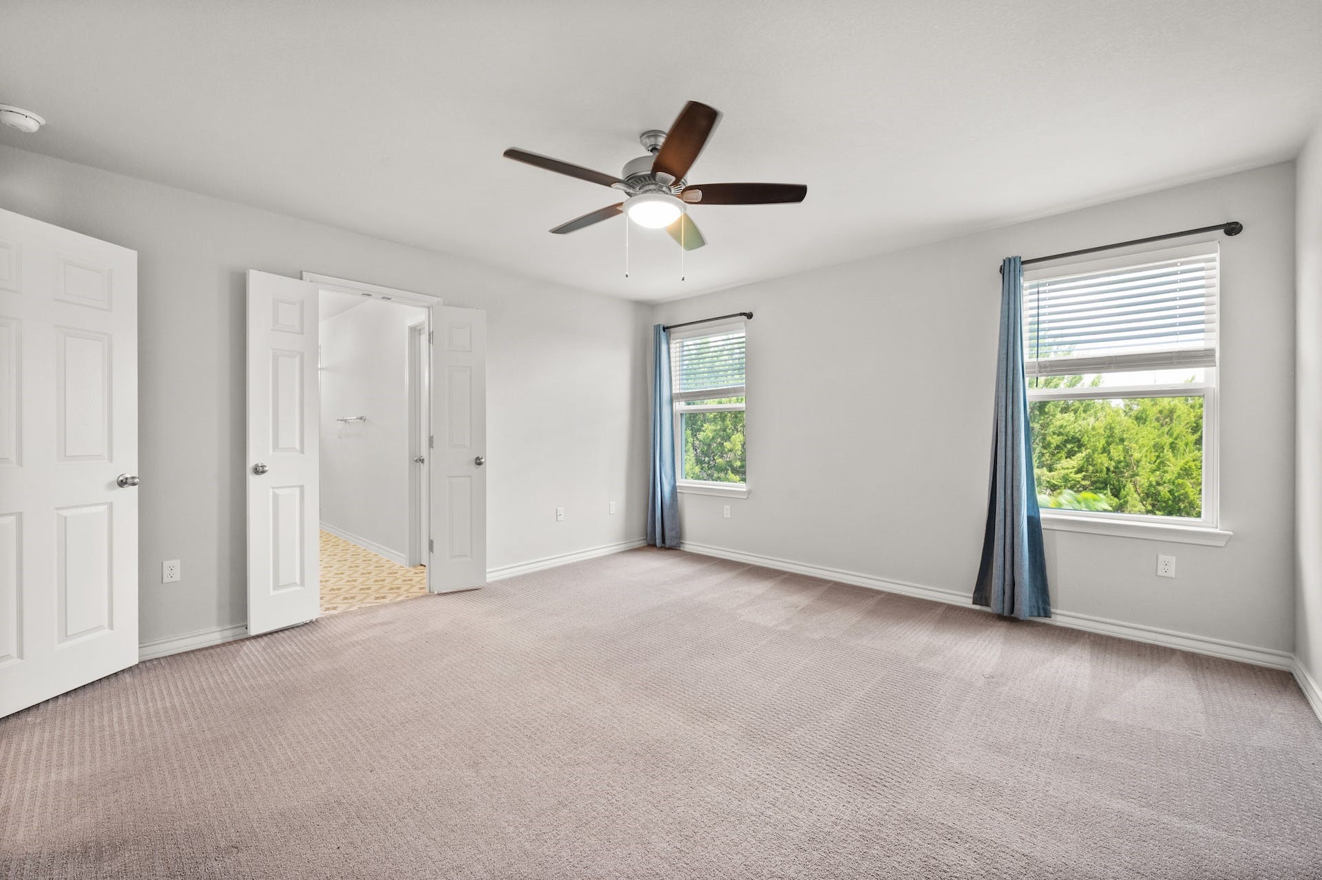 5107 Lemon Tree Path, Unit 127 Austin, TX 78723 - Photo 20 of 40 a view of empty room with windows and ceiling fan