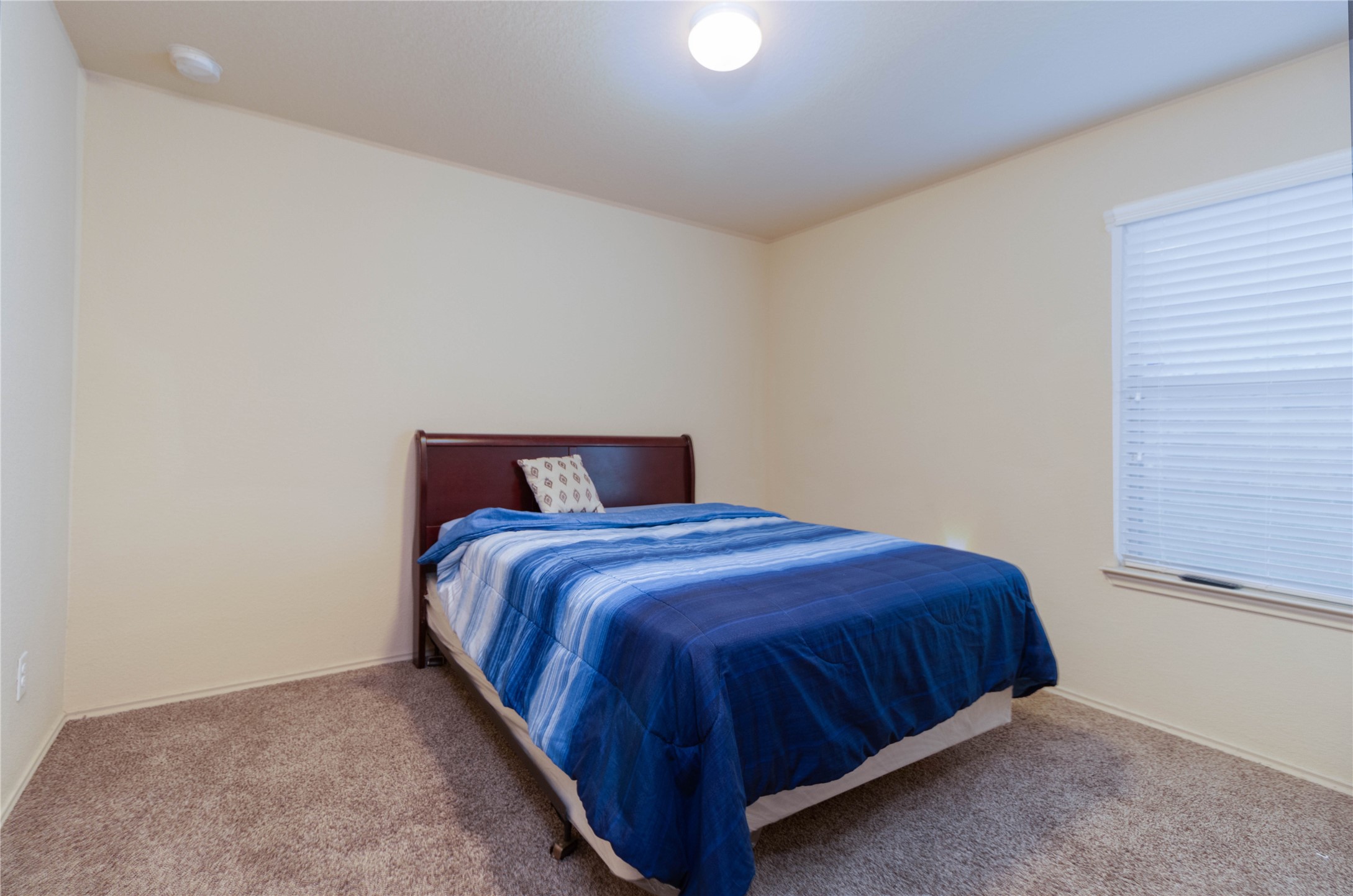24423 Raindrop Poppy Drive Spring, TX 77373 - Photo 17 of 29 a bedroom with a bed and window