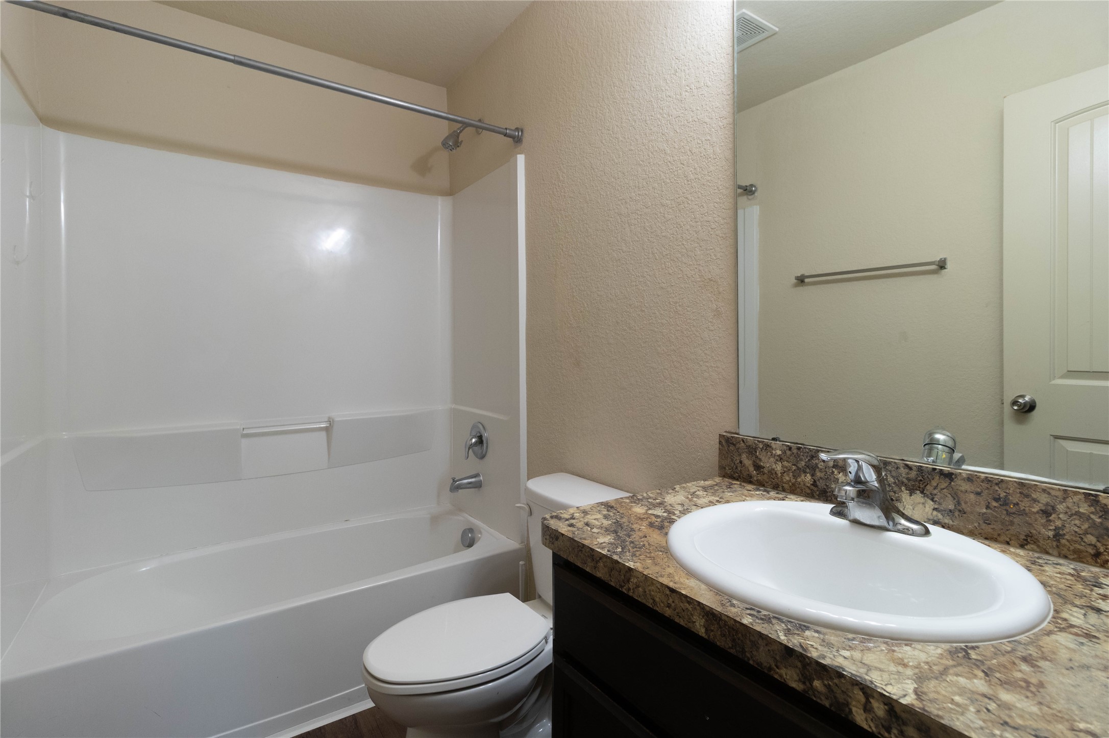 24423 Raindrop Poppy Drive Spring, TX 77373 - Photo 20 of 29 a bathroom with a granite countertop sink toilet and shower