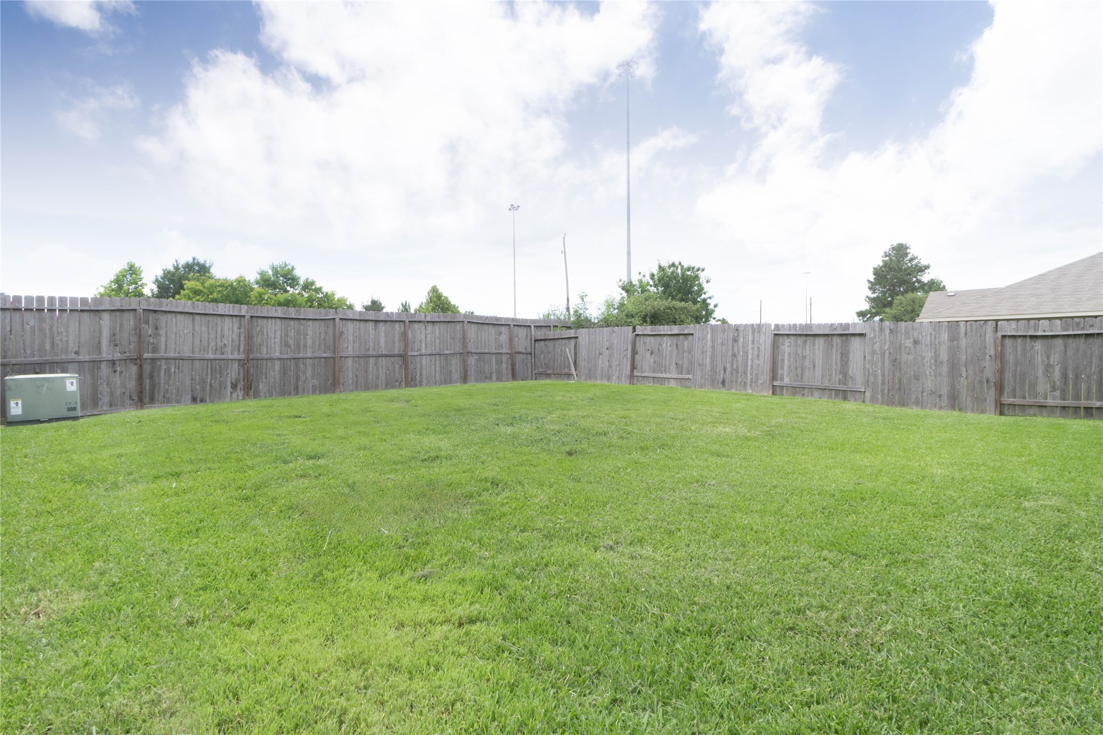 24423 Raindrop Poppy Drive Spring, TX 77373 - Photo 26 of 29 a view of a backyard with a small cabin and wooden fence